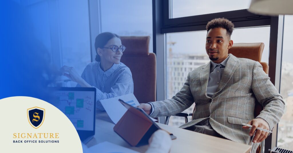 Healthcare staffing professionals review credentialing file compliance requirements together.